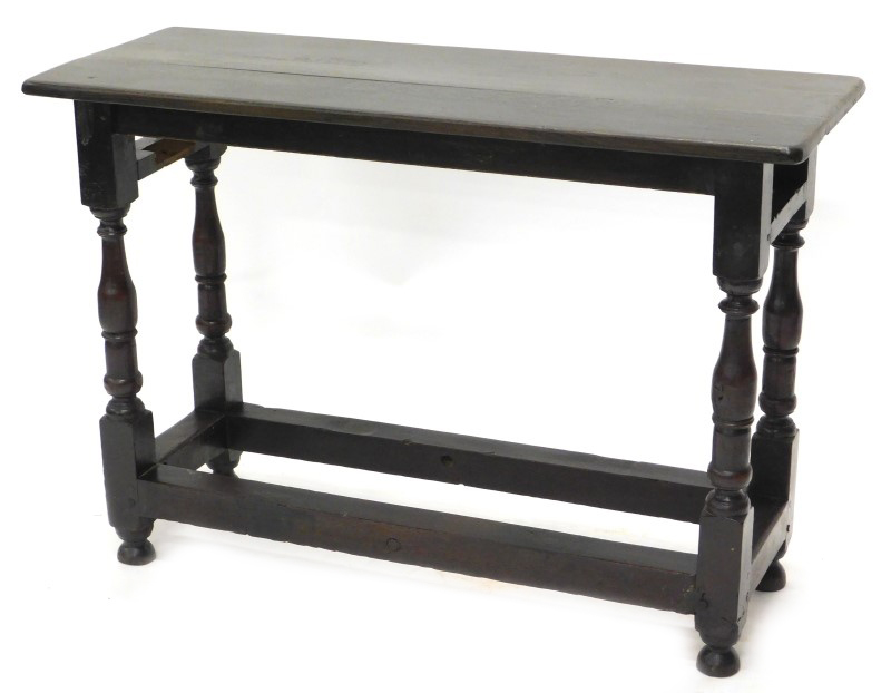 An oak side table, with a rectangular top on turned supports with stretchers, the stretchers from