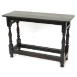 An oak side table, with a rectangular top on turned supports with stretchers, the stretchers from