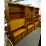 A three section Nathan type teak room unit, with panel doors to base.