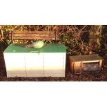 A metal and wooden slatted bench, a garden trunk, a metal cockerel and a rabbit hutch.