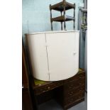 A mahogany office desk with leather insert, a white painted demi lune cabinet, and a two tier