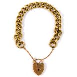 A 9ct gold curb link bracelet, on a heart shaped padlock clasp, with safety chain as fitted, 44.0g.