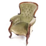 A Victorian mahogany spoon back nursing chair, upholstered in green button back fabric, raised on
