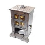 A Victorian cast iron and tin gas stove casing, set to the front with four leaf decorated tiles,