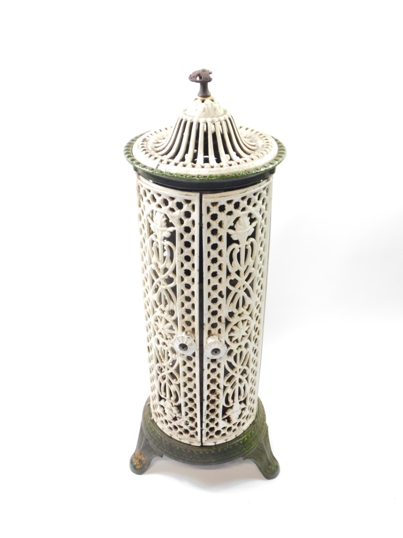 A Victorian white and green cast iron cathedral heater by Nestor Martin, with pierced floral and