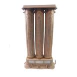 A Victorian cast iron oil and gas radiator, of three column form, above a glass paneled drop