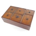 A Georgian mahogany spice box, of rectangular section, with six staggered and vary sized drawers,