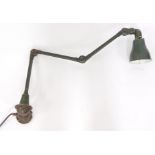 A early 20thC vintage Invisaflex industrialist wall mounted angle poise type lamp, painted in
