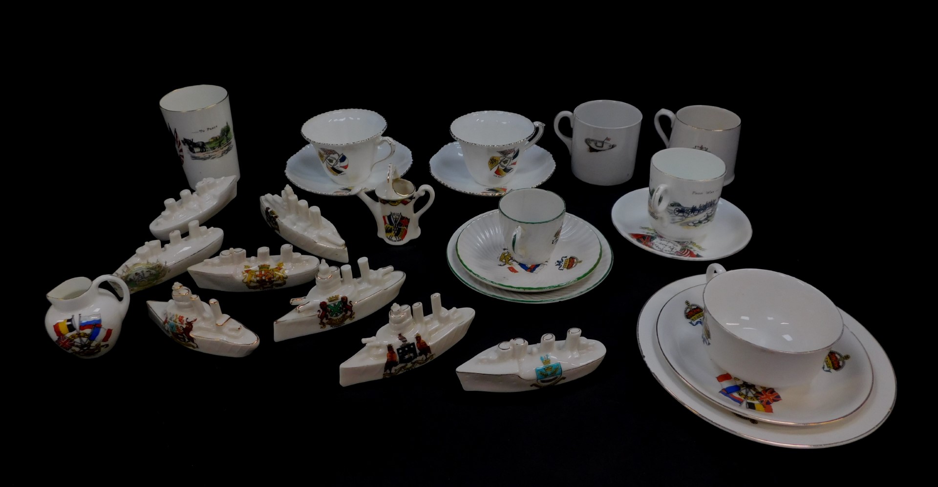 Eight crested china porcelain models of battle ships and other naval craft, crested and