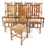A set of eight 1920's oak single dining chairs, with drop-in seats, raised on turned legs, united