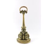 A Victorian brass and cast iron doorstop, of scrolling foliate form, 35cm high. (AF)