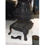 A Masport Yukon late 19thC cast iron pot belly stove, of fluted globe form, raised on an iron base