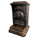 A French cast iron late 19thC stove, with a hinged lid, rectangular body and shaped hearth with