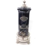 A St Joseph Couvin Le Salamandre stove, cast iron, polished white metal and black enamel, of