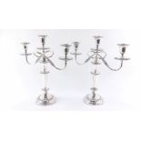 A pair of three branch silver plated candelabra, with detachable upper sections and nozzles,