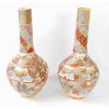 A pair of Japanese early 20thC satsuma bottle vases, decorated with panels of deities and other
