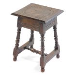 A Victorian stool come occasional table, the square hinged top carved with a portrait of an elderly