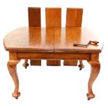 A Victorian light oak oval wind-out dining table, with three additional half leaves, raised on