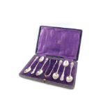 A set of six George V silver coffee spoons, and a pair of sugar tongs, cased, Walker and Hall,