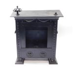 A Continental early 20thC black painted tin gas heater, of neo classical form, innards strip out,