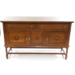 A Victorian oak sideboard, with two drawers over three cupboard doors, raised on spiral twist