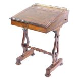 A Victorian rosewood davenport, with a brass galleried top and tooled brown leather writing slope,