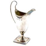 A George III silver helmet shaped cream jug, raised on a square base, George Gray, London 1784, 3.