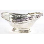 An Edward VII silver oval basket, with swing handle, with pierced and engraved foliate decoration,