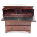A George III mahogany and satin wood cross banded secretaire chest, the secretaire drawer opening to