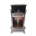 A Petrolux tin and copper conservatory heater c1920, with an open front containing a burner, cast