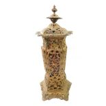 A cast iron rococo style free standing oil heater, with cover, of pentagonal baluster form, with