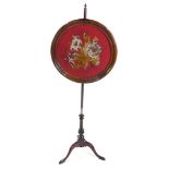 An Edwardian mahogany pole screen, the circular screen with wool and bead work floral decoration,