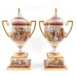 A pair of Vienna style late 19thC porcelain vases and covers, mounted on plinths, of twin handled
