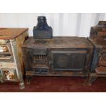 A cast iron early 20thC kitchen range 'The Suffolk Belle', by E L Hunt Ltd, Ipswich., raised on