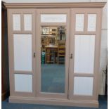 A Victorian mahogany compactum wardrobe, later painted in mushroom brown and white, the outswept