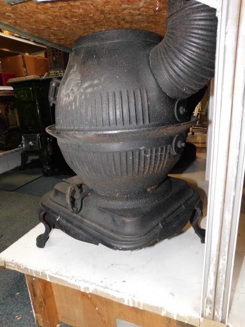 A Masport Yukon late 19thC cast iron pot belly stove, of fluted globe form, raised on an iron base - Image 4 of 4