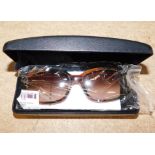 A pair of Calvin Klein tortoiseshell rimmed sunglasses, CK981S, cased.