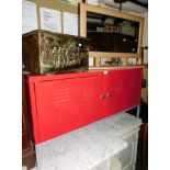 A red metal audio visual cabinet, 62cm high, 119cm wide, 36cm deep, with internal shelves and