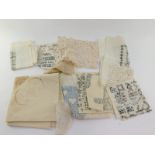 A linen and lace tablecloth, doilies and mats, sampler squares, etc. (1 tray)