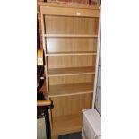 An oak effect bookcase, enclosing five shelves, 195cm high, 89cm wide, 40cm deep.