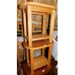 A pair of blonde oak side tables, with oval tops, 50cm high, 51cm wide, 36cm deep.