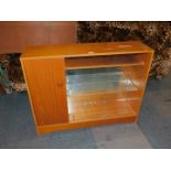 A teak side cabinet, with two sliding glass doors and side cupboard, 82cm high, 105cm wide, 29cm