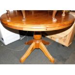 A circular pine kitchen table, 78cm high, 107cm diameter.