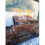 A teak folding garden table and two folding chairs. (3)