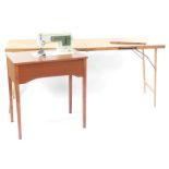 A Singer sewing machine, enclosed with a teak table, together with a pasting table, 77cm high,