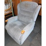 An electric rise and recline armchair, upholstered in a blue grey chenille fabric.