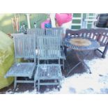 A set of four teak folding garden chairs, together with a cast metal patio table. (5)