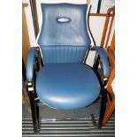 A blue and cream leatherette armchair with chrome frame.