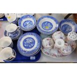 A blue and white pottery part dinner and tea service decorated in the Willow pattern, together