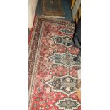 A modern Persian style rug, with red ground and geometric design, 220cm x 158cm., together with a